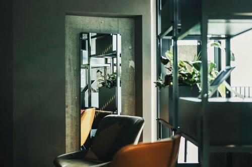 a room with chairs and a window with plants at Fritz Lauterbad in Freudenstadt