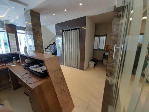 a room with a lobby with a counter and a door at Hotel Wizard Palace in Aurangabad