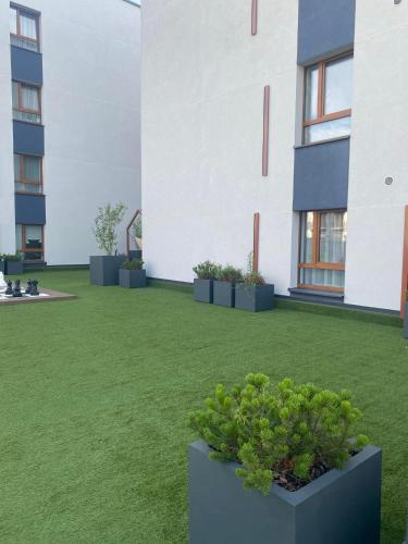 a courtyard with potted plants in front of a building at Two bedroom LUXURIOUS Spacios Apartment in Vilnius