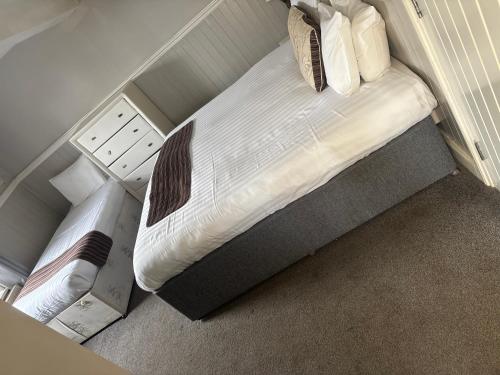 a small bedroom with a bed with a night stand at The Anchor Inn in Sutton Bridge