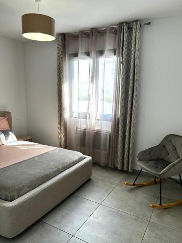 a bedroom with a bed and a chair in it at L'Ostal Des Amis in Servian