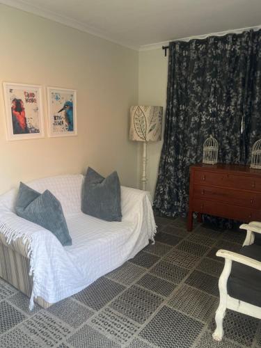 a bedroom with a bed and a dresser and a window at Broadway in Durban
