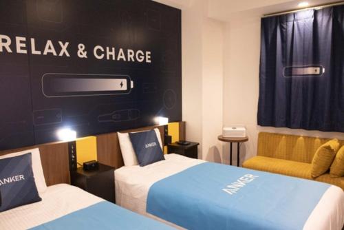 a hotel room with two beds and a couch at Henn na Hotel Maihama Tokyo Bay in Urayasu