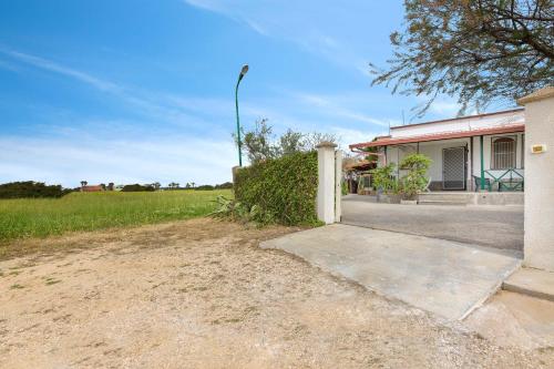 a house with a driveway in front of it at Villa Imma by BarbarHouse in Punta Prosciutto
