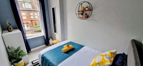 a yellow rubber duck sitting on a bed in a room at Single Bed at Cozy Hailsham in London