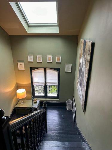 a hallway with a skylight and a desk and a window at Demeure Architecte avec Piscine Privee in Le Vésinet