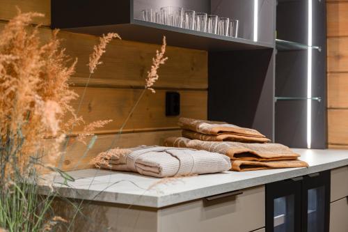 a pile of towels sitting on top of a counter at Aurora B Luxury Lodge in Kuusamo