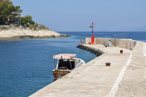 a boat is docked at a dock in the water at Villa Lav in Prigradica