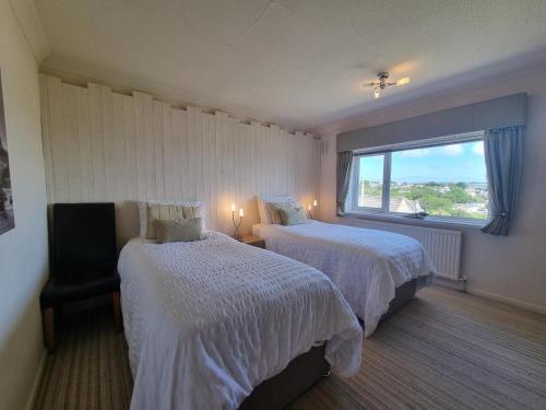 a hotel room with two beds and a window at 3 Bed in Newlyn oc-s33015 in Newlyn