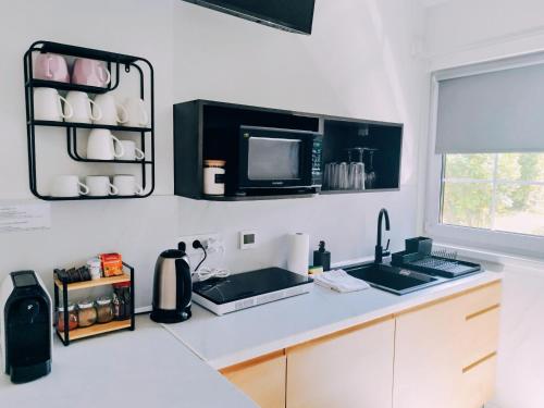 a kitchen with a sink and a microwave at Aquamara Aquapark Tatralandia in Liptovský Mikuláš