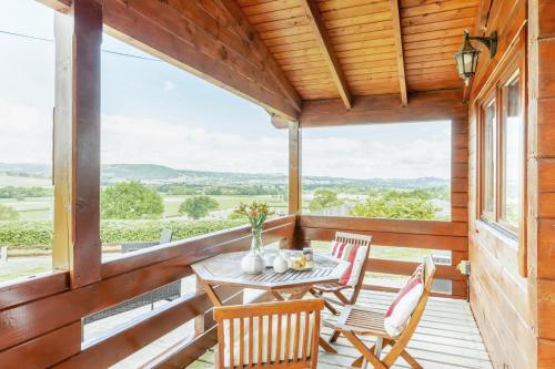 a wooden porch with a table and chairs on it at 1 Bed in Llandinam oc-t33065 in Llandinam