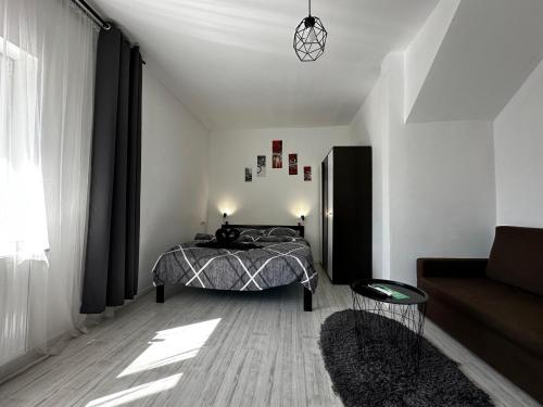 a bedroom with a bed and a couch at Vila ANA in Cluj-Napoca