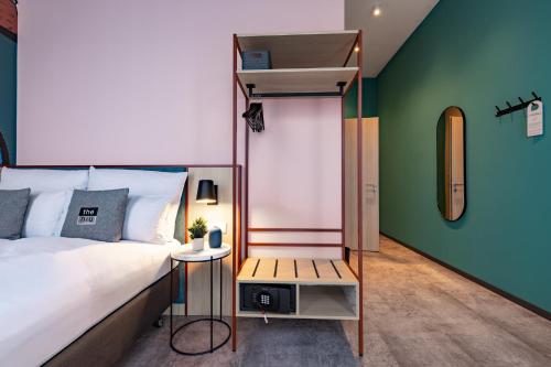 a bedroom with a bed and a loft bed at Holiday Inn - the niu, Pax Berlin Airport by IHG in Berlin