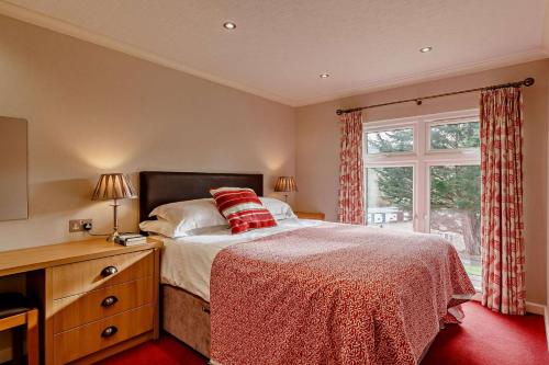 a bedroom with a bed and a window at 3 Bed in Two Waters Foot oc-m27335 in Cardinham