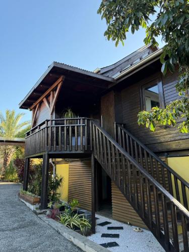 a house with a staircase in front of it at LODGE INDIGO - Bungalow & RDC indépendant proche aéroport in Sainte-Marie