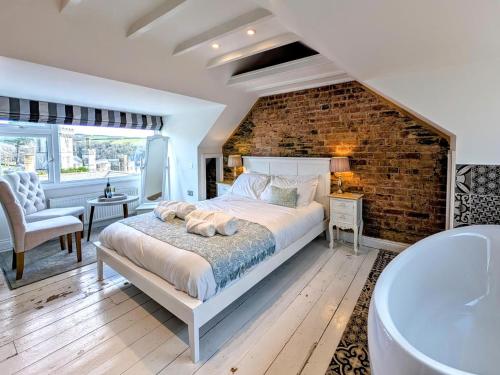 a bedroom with a large bed and a bath tub at 3 Bed in Fowey oc-g33050 in Fowey