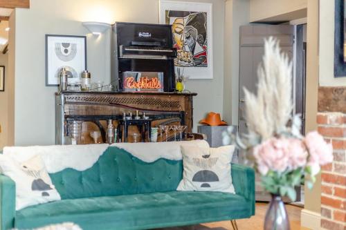 a living room with a green couch and a fireplace at 5 Bed in Blofield oc-s33037 in Blofield