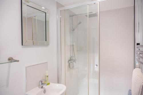 a white bathroom with a shower and a sink at 3 Bed in Netherton oc-w32951 in Alnham