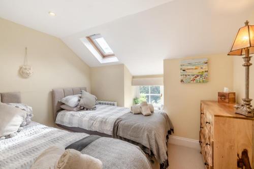 a bedroom with two beds and a window at 3 Bed in Netherton oc-w32951 in Alnham
