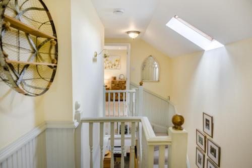 a hallway with a white staircase with a skylight at 3 Bed in Netherton oc-w32951 in Alnham