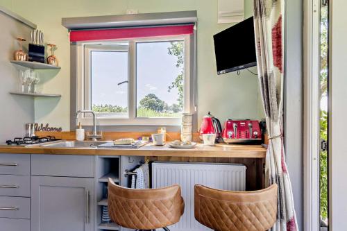 a kitchen with a counter and a sink and a window at 1 Bed in Llandeilo oc-w33068 in Llanddeusant
