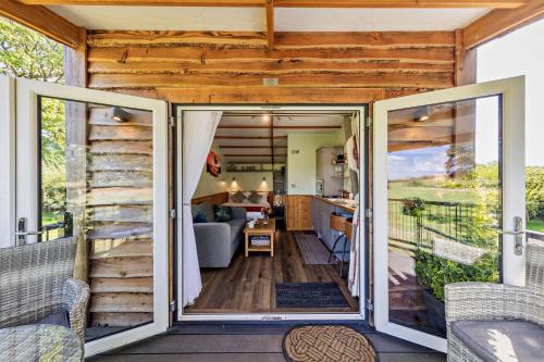 a tiny house with sliding glass doors on a deck at 1 Bed in Llandeilo oc-w33068 in Llanddeusant