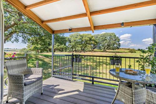 a patio with a table and chairs on a deck at 1 Bed in Llandeilo oc-w33068 in Llanddeusant
