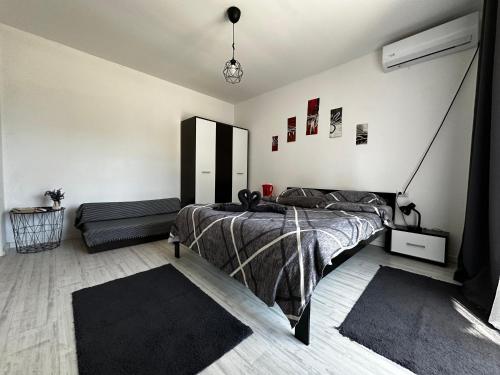 a bedroom with a bed and a couch at Vila ANA in Cluj-Napoca