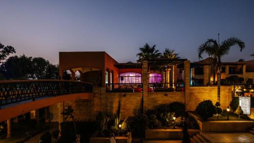 a building with a bridge in front of it at night at Hotel Prestige Agadir Boutique & SPA in Agadir
