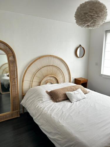 a bedroom with a large bed and a mirror at Chambre et petit déjeuner in Seclin