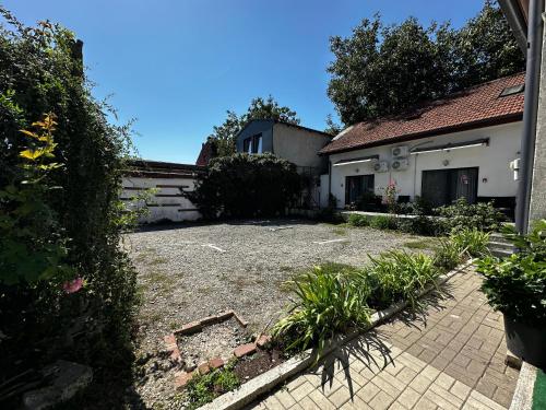 a house with a gravel yard in front of it at Vila ANA in Cluj-Napoca