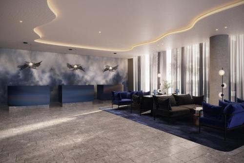 a lobby with blue furniture and birds on the wall at Crowne Plaza Geelong by IHG in Geelong