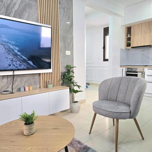 a living room with a tv and a chair at Apartment Nemanja by Princess Milena in Čučići
