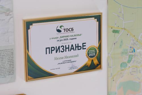 a framed sign on a wall next to a map at Smestaj Dzentlmen in Soko Banja