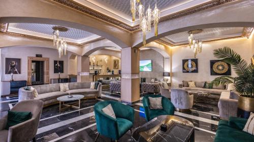 a lobby with couches and chairs and a chandelier at Hotel Prestige Agadir Boutique & SPA in Agadir