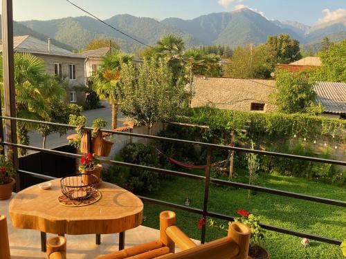 a balcony with a table and a view of a yard at Mountain View in Lagodekhi
