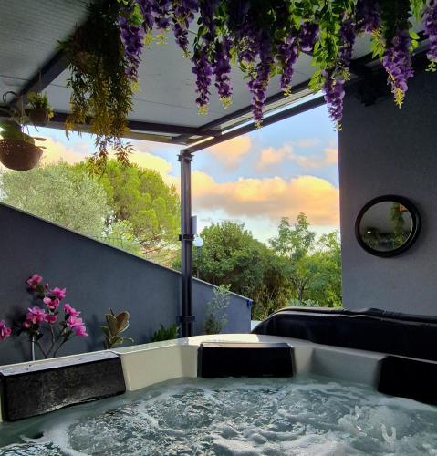 a bath tub in a room with a view at Chalet Ponte Paradiso Suite & SPA in Santa Cristina Gela