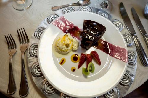 a plate of food with strawberries and ice cream at La Rabida Hotel Boutique in Quito