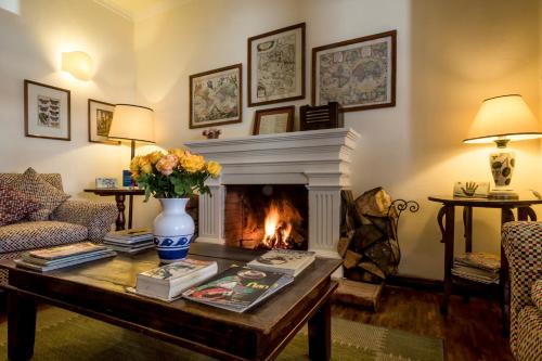 a living room with a fireplace and a table at La Rabida Hotel Boutique in Quito