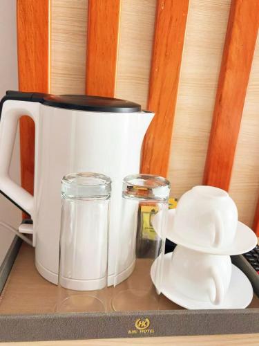 a counter top with a coffee pot and a pitcher of milk at 凯丽酒店Kiri Hotel at Kigali Rwanda in Kigali