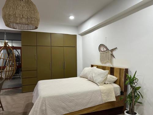 a bedroom with a bed and a green cabinet at Coral Loft in Antón Lizardo