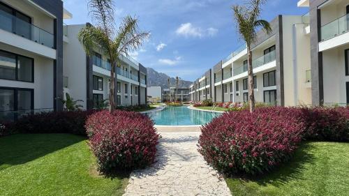 a courtyard with a swimming pool in a building at Luxurious 1 bedroom duplex apartment in Palmera Resort in Ayios Yeoryios