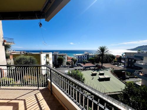 a balcony with a view of the beach and the ocean at Suite A 2 passi dalla Spiaggia - Ospedaletti in Ospedaletti