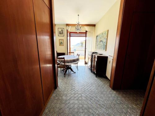 a hallway with a table and a dining room at Suite A 2 passi dalla Spiaggia - Ospedaletti in Ospedaletti