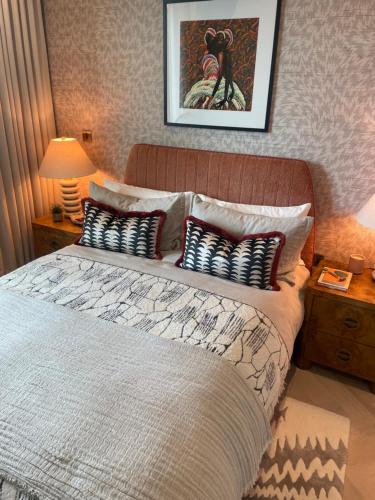 a bedroom with a large bed with pillows on it at London Residence in London