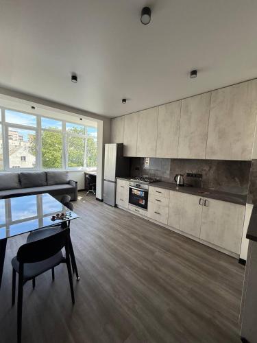 a large living room with a couch and a kitchen at Апартаменти ВІП вул Під Голоском 15 б 9-1 in Lviv
