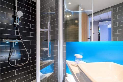 a bathroom with a shower and a sink at Holiday Inn Express Mechelen City Centre by IHG in Mechelen