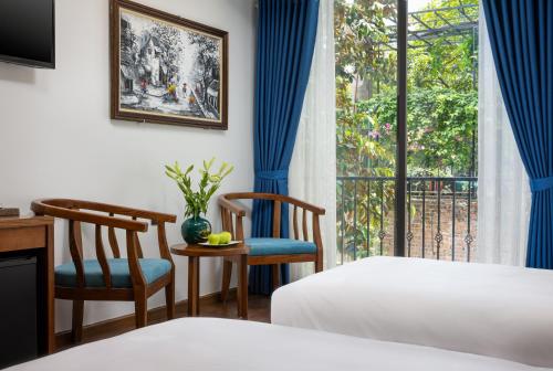 Postel nebo postele na pokoji v ubytování Tam Coc Condelux Boutique Hotel