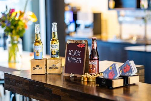a table with three bottles of beer on it at Holiday Inn Express Mechelen City Centre by IHG in Mechelen