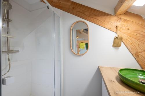 a bathroom with a shower with a mirror and a sink at Maison Outhera - Chambre d'hôtes in Orcières